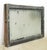 Reclaimed rectangular shaped window with a wood frame, steel sides, and a clear wormy chicken wire glass pane. It was...