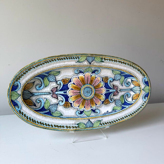 Vintage Italian pottery cool toned daisy motif hanging plate. The long oval shape is stunning above doorways, contrasting...
