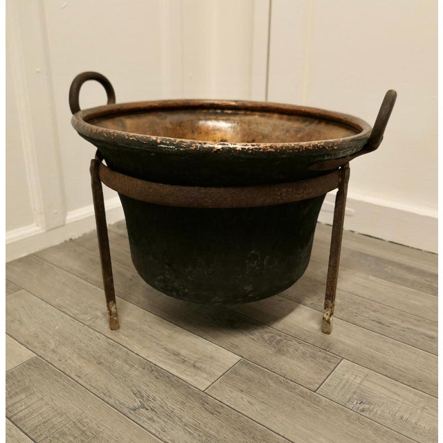 Hand beaten copper cooking cauldron on stand, log basket. This is a lovely early Cooking Pot, it is made in hand beaten...