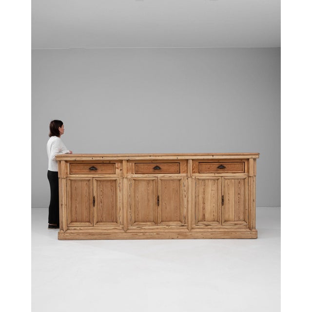 This buffet carries genuine presence, its natural light oak, two-tone paneled doors and drawers immediately setting the...
