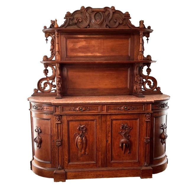 American Renaissance Carved Oak Sideboard, late 19th to early 20th.. It supports lovely marble top, four drawers and four...