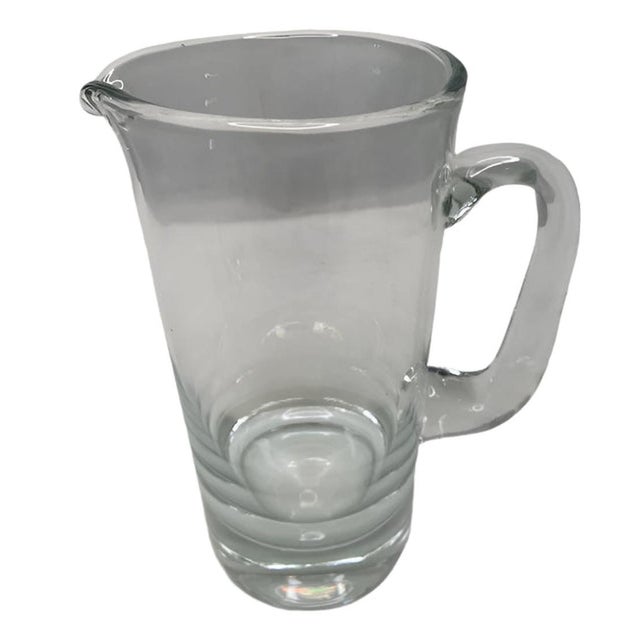 Elevate your bar experience with our Vintage Glass Bar Pitcher. Made from high-quality glass, this modern pitcher adds a...