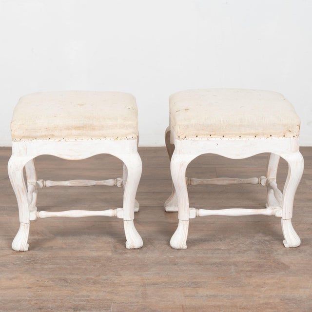 This lovely pair of pine Swedish stools or tabourets have curved, cabriolet legs with gently turned support stretchers...