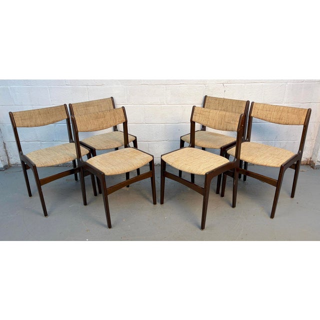 Elegant set of six mid-century modern Danish dining chairs Attributed to Erik Buch, Model 49. Crafted in richly grained...