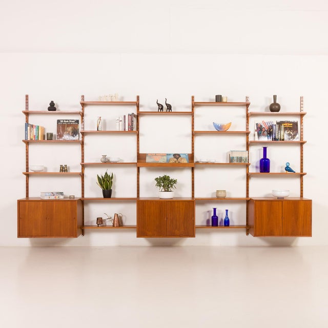 This extra wide teak wall unit was designed by poul cadovius and made by his company cado in the 1960s. Its simple form...