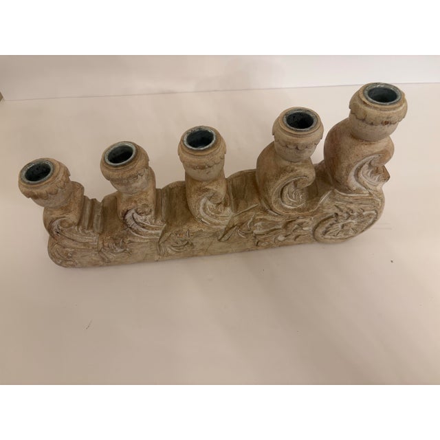 Carved wood with very detailed work used as a regular taper candle holder with ornate scroll work design. It was made in...