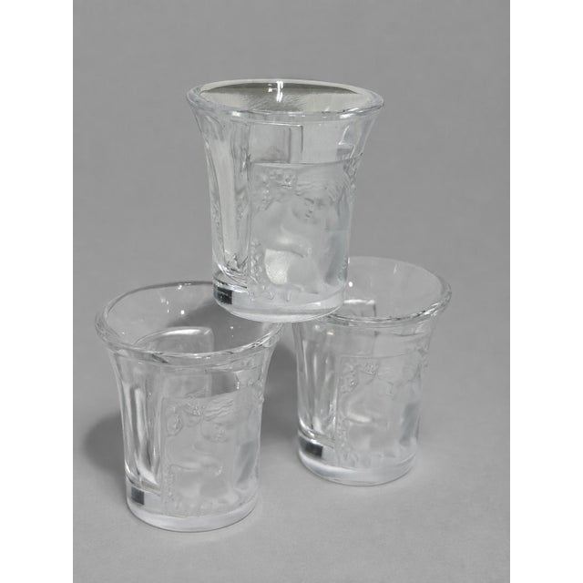 A fine set of six Lalique France crystal liqueur or shot glasses in the celebrated Enfants pattern, originally designed by...