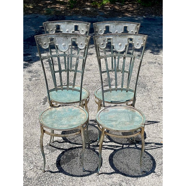 Infuse your indoor or outdoor space with whimsical vintage charm using this captivating set of four wrought iron carousel...