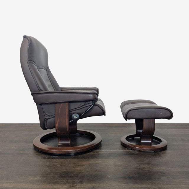 This Stressless lounge chair and matching ottoman offer classic comfort with a sleek, dark brown leather finish and sturdy...