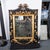 Gilded and ebonized oak Baroque style mirror. Meticulously restored with 23K gold leaf detailing.