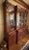 Elegant Baker Furniture breakfront China cabinet crafted in rich flame mahogany with a traditional Georgian / Chippendale-...
