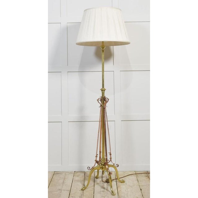 Brass and copper standard lamps The design attributed to W.A.S. Benson, with a central brass column and four shaped legs...