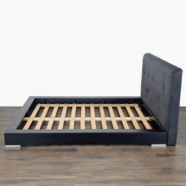 This BoConcept bed frame features a sturdy black wooden base with a stylish upholstered headboard. The frame uses durable...
