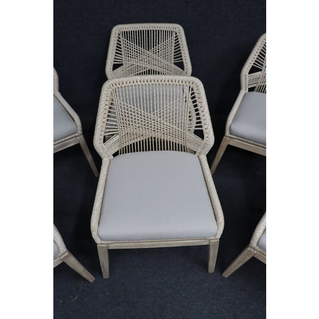 Set of six Essentials for Living “Loom” dining chairs featuring an intricate woven rope back design, natural gray wood...