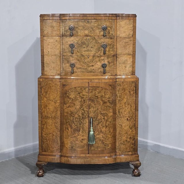 Superior serpentine burr walnut linen press, ebony stringing, brass handles, standing on lions paw feet, three drawers...