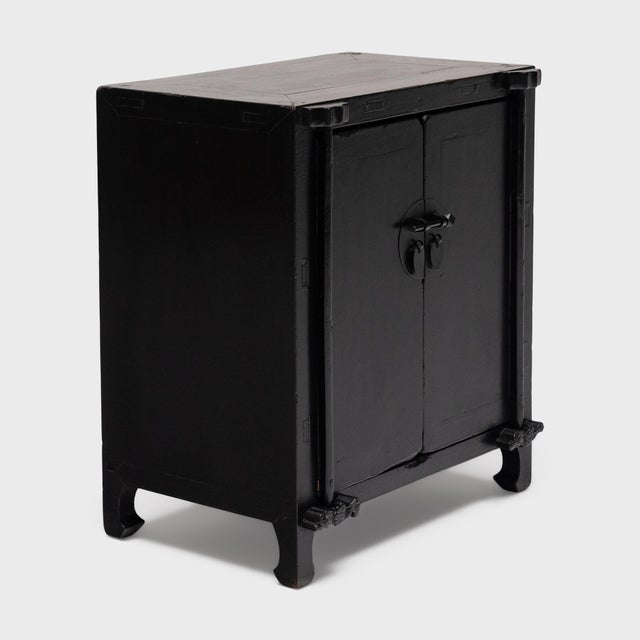 Crafted of elm with traditional joinery, this antique Chinese side cabinet has clean lines and an uncluttered design....