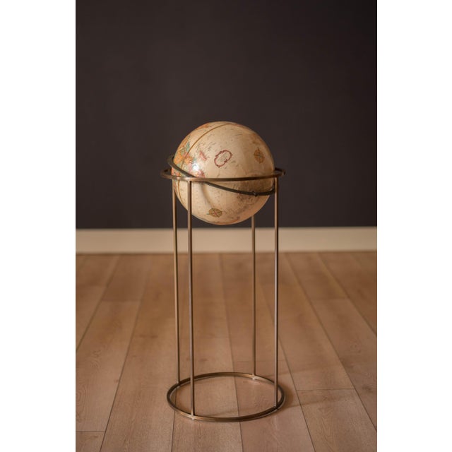 Vintage world map Replogle globe with stand in brass, circa 1970's. This piece rotates on a full swing meridian and...