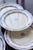 Set of six Gien "Royal" pattern dinner plates in ivory earthenware, with a scalloped rim and double frieze: a garland of...
