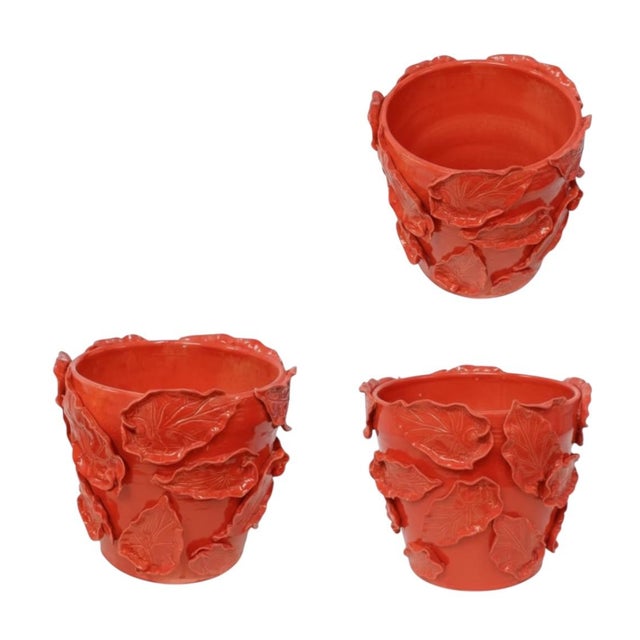 This handmade ceramic cachepot features a richly textured surface with bold, dimensional leaf motifs and a sculptural,...