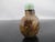 Small antique, most likely Qing dynasty era, Chinese snuff bottle. Small round bottle in translucent 'Shadow" agate...