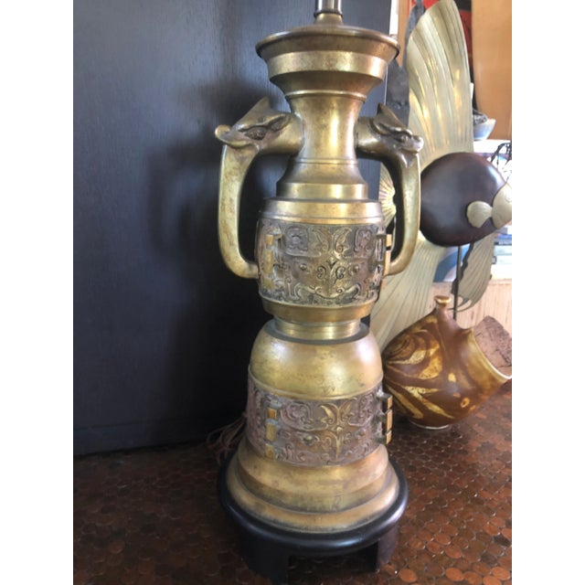Tall brass table lamp with wonderful dragon heads. Intricate design work and with a wonderful patina. Working condition as...