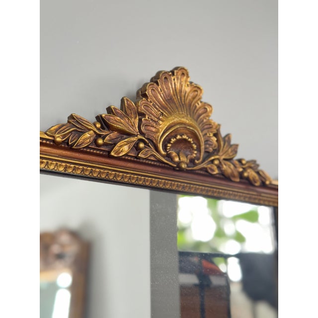Rectangular wall mirror with giltwood frame and carved crest, late 20th century. Frame with molded edge, bead detailing,...