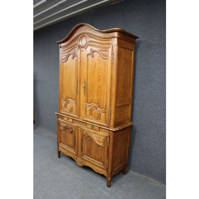 18th century French Provincial linen press handcrafted in solid pine with a warm natural patina. This two-piece cabinet...