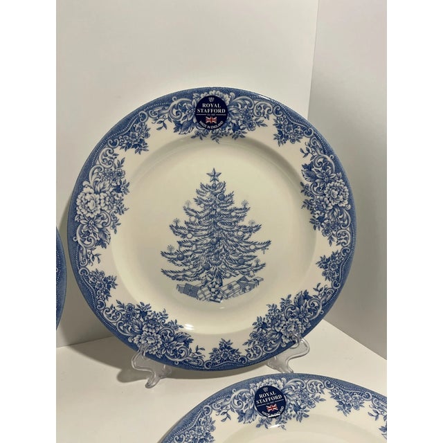 Celebrate the season in classic style with this elegant Set of 4 Royal Stafford Blue & White Christmas Tree Dinner Plates....