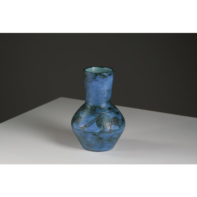 An elegant baluster-shaped vase by Jacques Blin, crafted from glazed ceramic in a deep, nuanced blue. Its decoration of...
