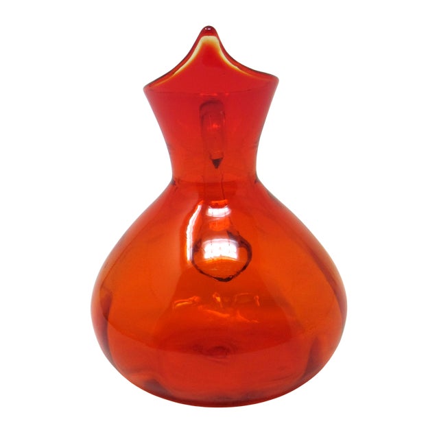 A lovely tangerine and amber hand-blown glass pitcher. Made by Rainbow Glass Co in 1969. The series number is #797, and...