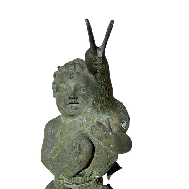 Antique Italian Bronze Fountain. Late 19th Century figure of a boy in a bronze Verdi Gris depicted holding a duck. The boy...