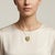 Discover the elegance of our Vintage Shield Shaped Pendant, a stunning brooch that features a beautifully crafted white...