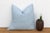 An eight-point star medallion, hand block-printed in white, traces softly across a powder blue linen ground on this pillow...