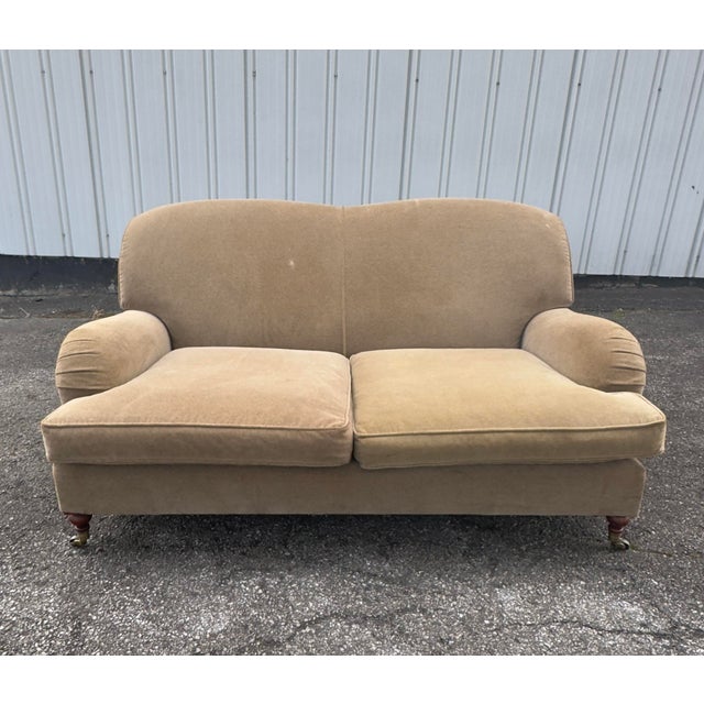 Ralph Lauren Wyland Loveseat Sofa in tan velvet fabric. The sofa has down wrapped seat cushions and turned wooden front...