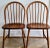 Elevate your space with this stunning pair of authentic mid-century Danish Modern Windsor chairs, expertly crafted by Tarm...