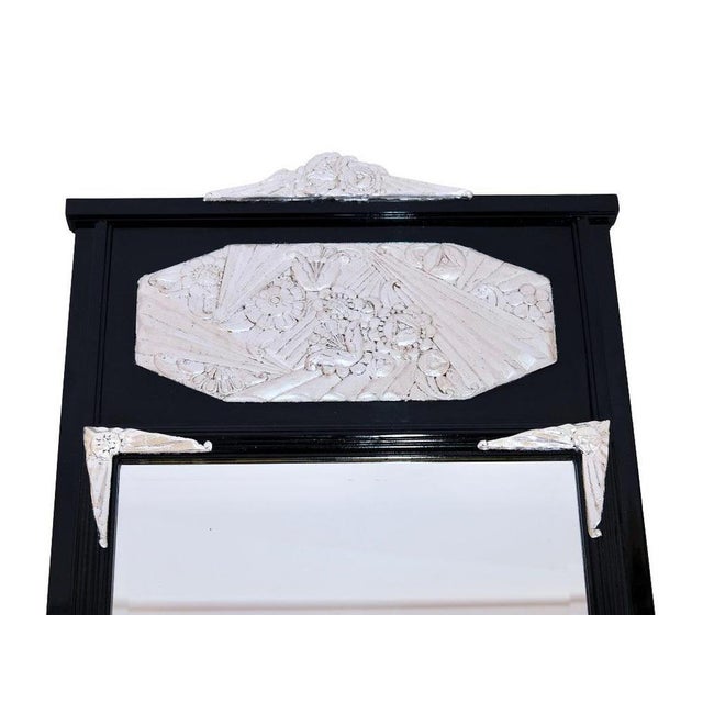 Decorative Art Deco mirror France around 1930. Wood painted black – flowers and blossoms silver-plated in the upper gable...
