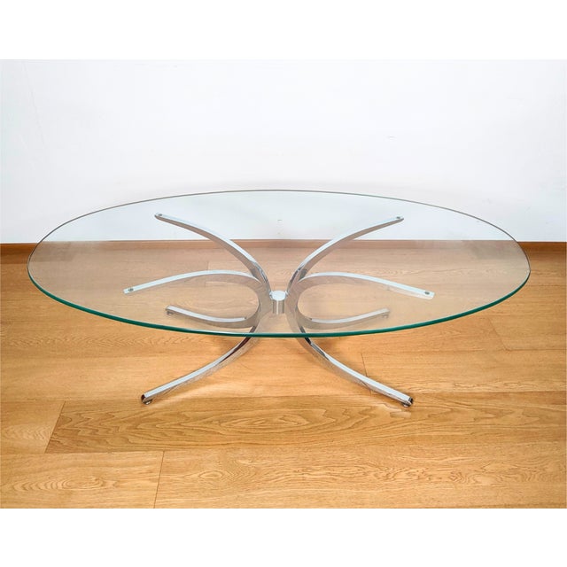 Elegant Space coffee table with a metal base. The table has an oval shape at the front.