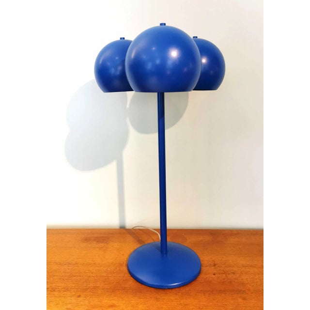 This table lamp was designed by Juanma Lizana during the 2000s. It features three bubble shades and a blue structure, with...