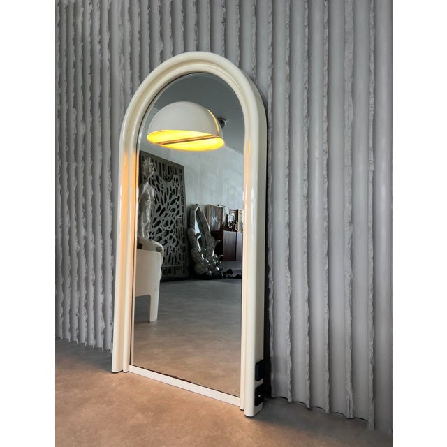 Bring home a true design classic from the 1970s. This arched mirror combines timeless retro aesthetics with clever...