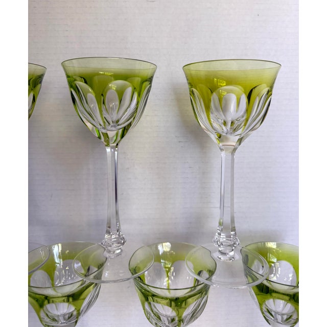 Here is a stunning set of seven vintage green overlay crystal wine glasses, attributed to Moser in the iconic Lady...