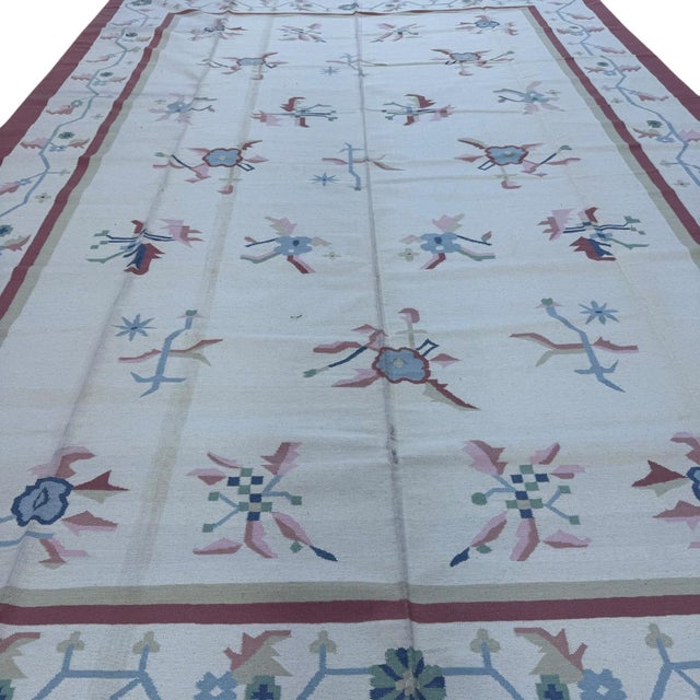 This handmade Indian dhurrie (flatweave kilim-style) rug is a celebration of simplicity, craftsmanship, and soft, refined...
