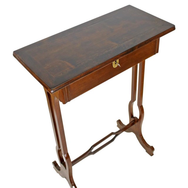 This as an elegant late Victorian smoking table. It contains a lockable tobacco storage. It was only touched up, no...