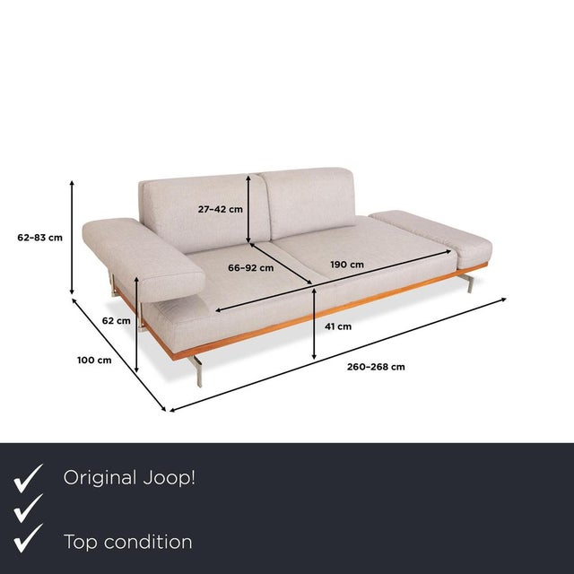 The Joop 8106 two-seater sofa is characterized by clean lines and a timeless look. The combination of light gray with wood...