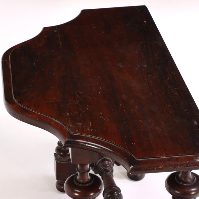 Finely constructed in walnut, this Italian console table features a shaped top supported by beautifully turned legs joined...