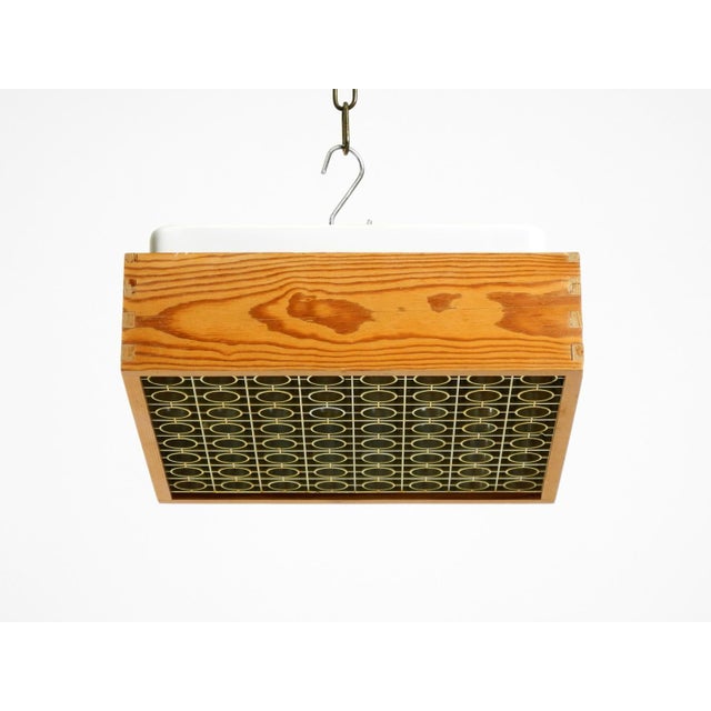 Beautiful 1970s squared ceiling lamp by alda. Made in sweden. the frame is made of pine wood. The golden diffuser is made...