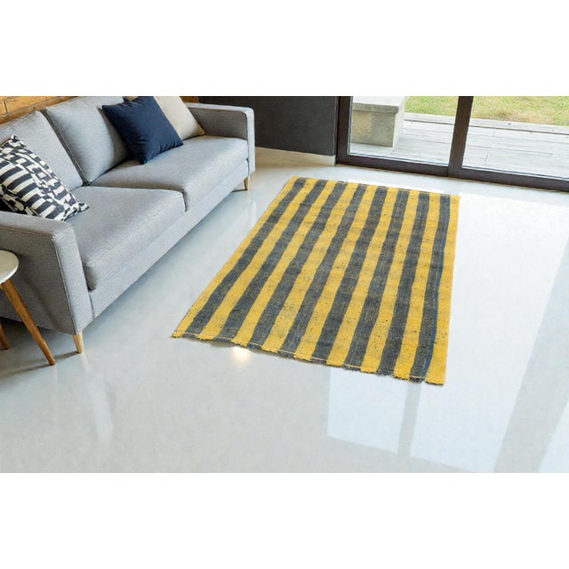 This is a vintage Turkish Oushak rug from the Mid 20th Century. The piece was hand-knotted.