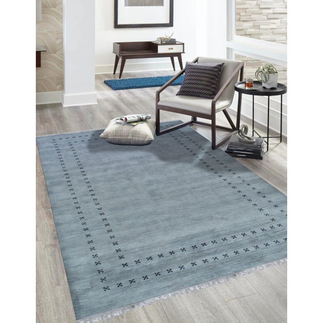 Jasmine Alluring Gray Handmade Wool Rug, Country of Origin: India. This exquisite piece defines contemporary elegance...