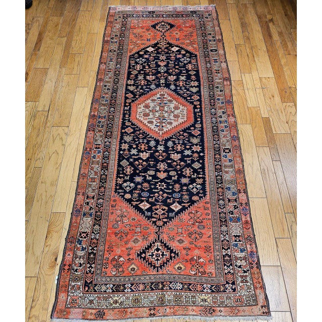 "This authentic early 20th century Persian Malayer tribal gallery rug is a striking example of traditional village weaving...