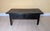 A beautifully timeworn primitive coffee table featuring a richly aged black painted surface and hand-built solid wood...