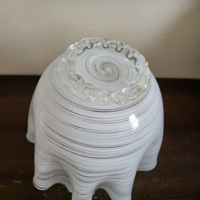 The result is a sculpture that plays with light and shadow. The folds of the "handkerchief" catch and bend the light,...